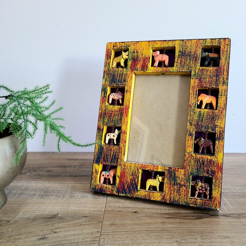 Indian wooden handcrafted picture frame with inserted moving animals.